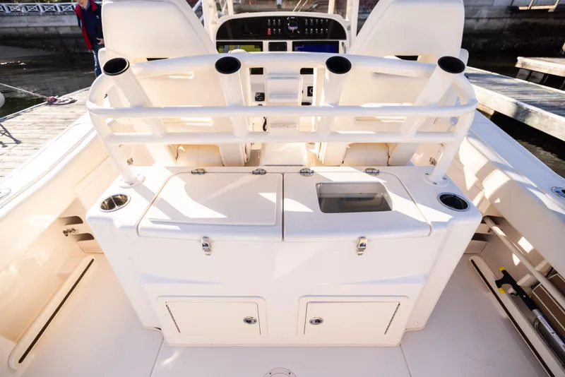 Slide: The Image of 2022 Grady-White 30.6 Canyon boat interior with rod holders and storage compartments. - 14