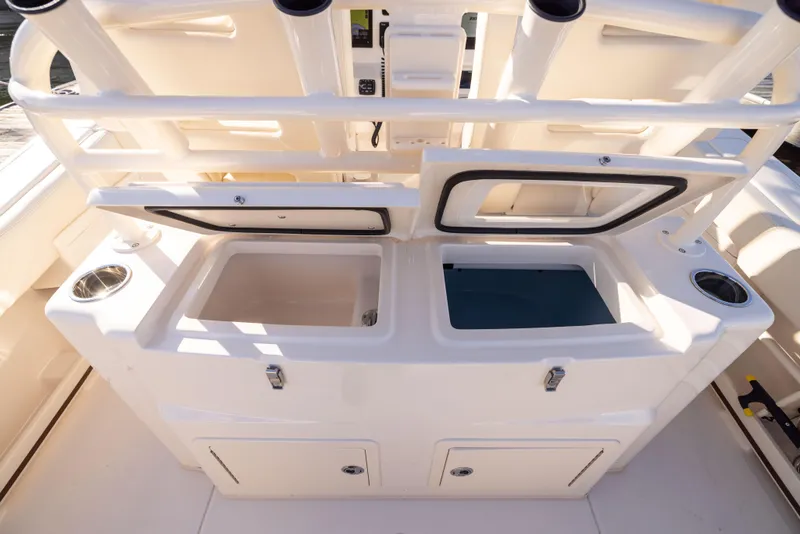 Slide: The Image of 2022 Grady-White 30.6 Canyon boat storage compartments and rod holders. - 15