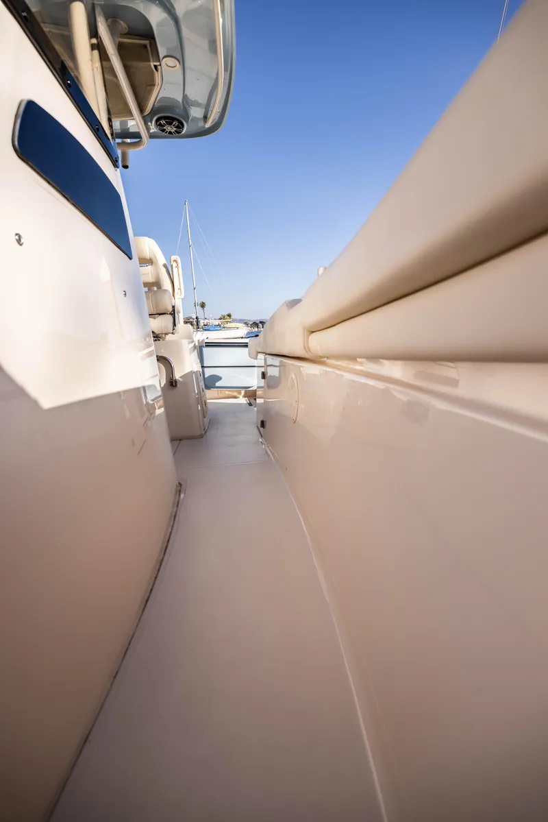 Slide: The Image of 2022 Grady-White 30.6 Canyon boat deck, sleek design, clear blue sky. - 20