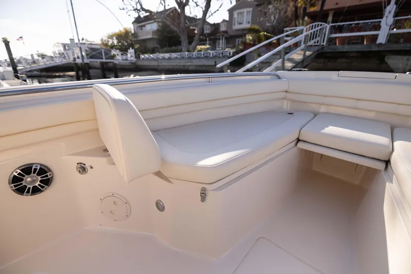 Slide: The Image of 2022 Grady-White 30.6 Canyon boat interior with cushioned seating and speaker. - 5