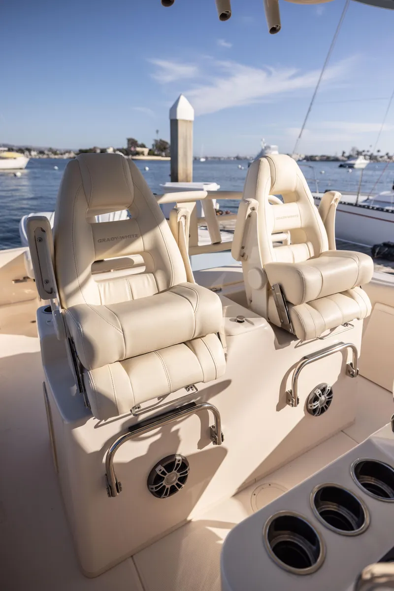 Slide: The Image of 2022 Grady-White 30.6 Canyon boat interior with luxurious seating and cup holders. - 7