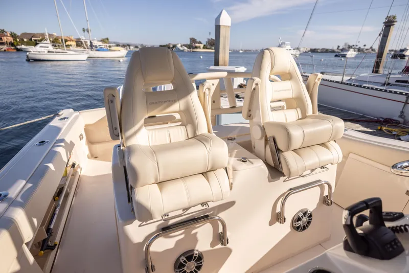 Slide: The Image of 2022 Grady-White 30.6 Canyon boat interior with luxurious seating on a sunny day. - 8