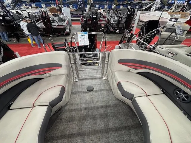 Slide: The Image of 2025 Barletta CORSA 23QC boat interior with plush seating at a boat show. - 10
