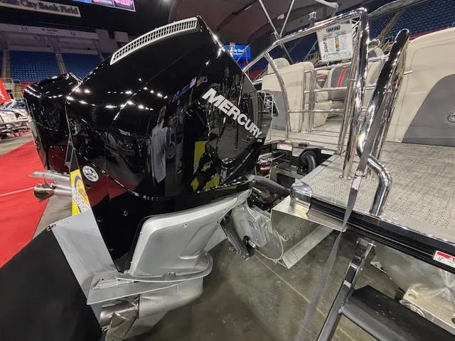 Slide: The Image of 2025 Barletta CORSA 23QC boat with Mercury engine displayed indoors. - 14