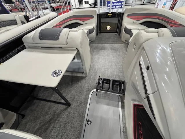 Slide: The Image of 2025 Barletta CORSA 23QC interior with plush seating and foldable table. - 25