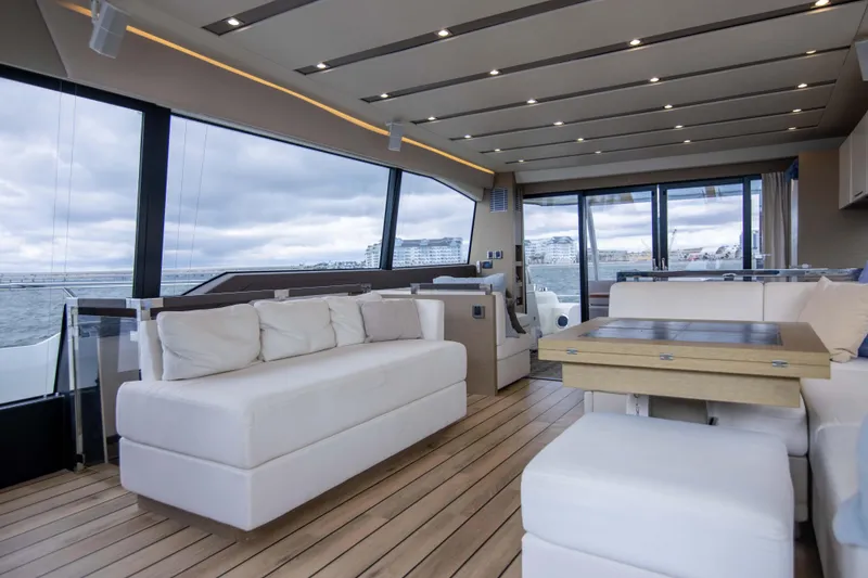 Slide: The Image of Luxurious interior of 2018 Prestige 680 Flybridge yacht with modern seating and panoramic windows. - 12