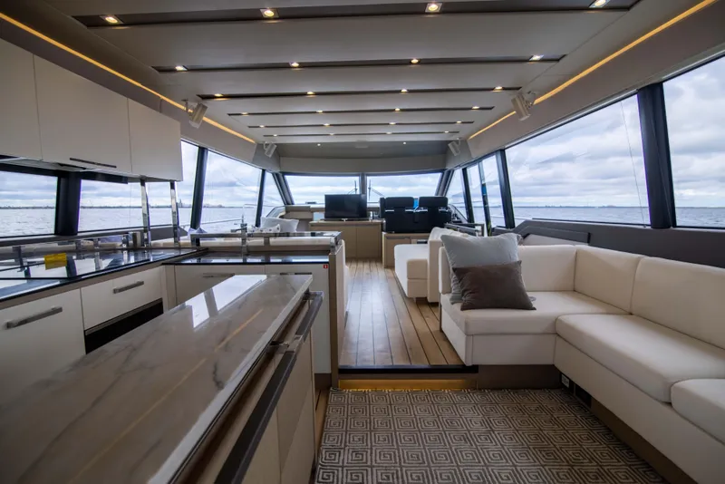 Slide: The Image of Luxurious interior of 2018 Prestige 680 Flybridge yacht with modern kitchen and seating area. - 14