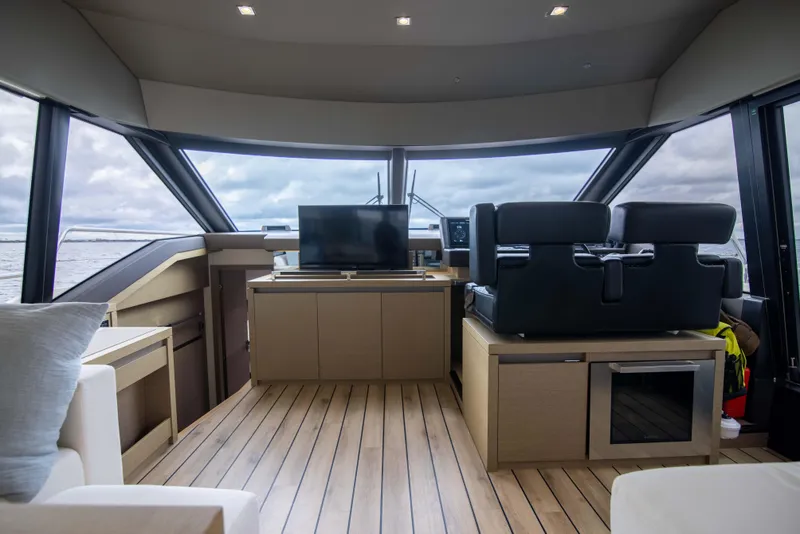 Slide: The Image of Luxurious interior of 2018 Prestige 680 Flybridge yacht with modern furnishings and panoramic windows. - 15