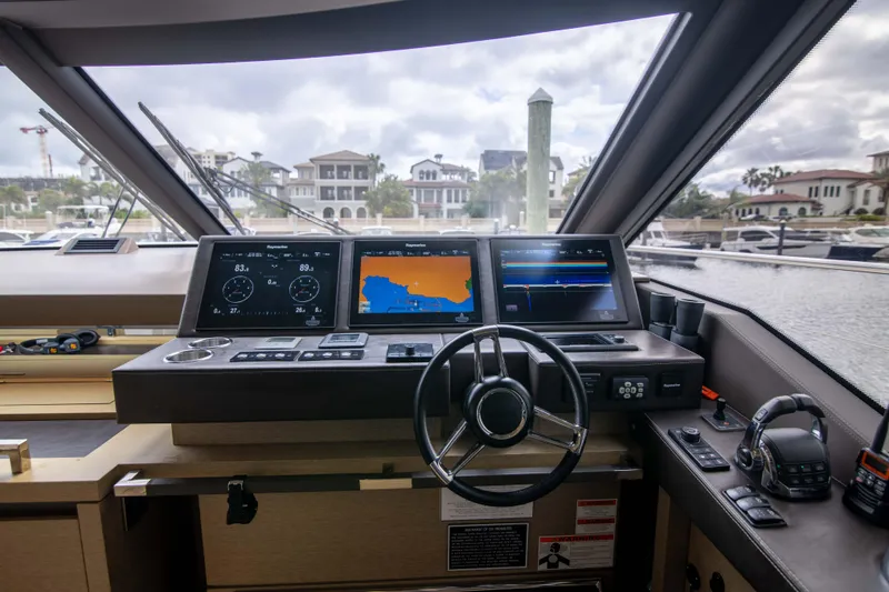 Slide: The Image of Cockpit of 2018 Prestige 680 Flybridge yacht with navigation screens and steering wheel. - 17
