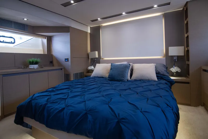 Slide: The Image of Luxurious bedroom in 2018 Prestige 680 Flybridge yacht with modern decor and blue bedding. - 27