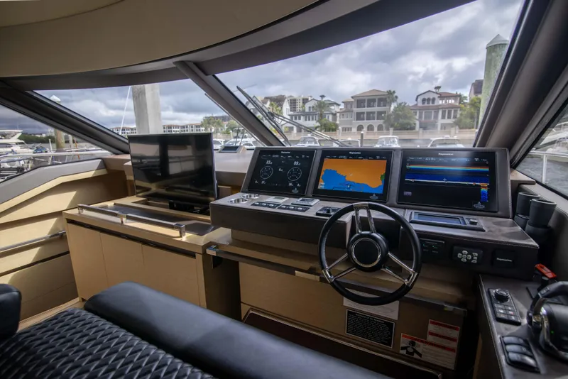 Slide: The Image of Prestige 680 Flybridge 2018 yacht helm with navigation screens and steering wheel. - 3