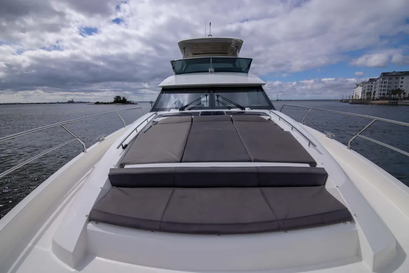 Slide: The Image of 2018 Prestige 680 Flybridge yacht with spacious deck and luxurious seating, cruising on open water. - 42