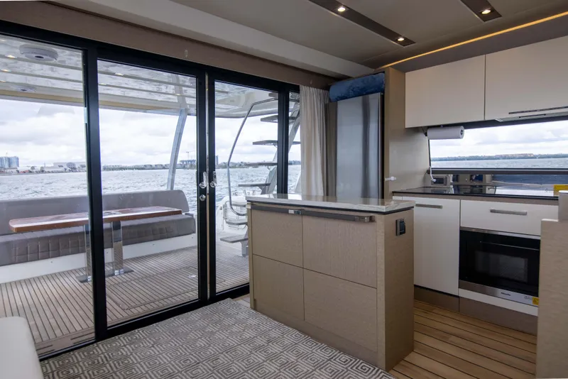 Slide: The Image of Luxurious interior of 2018 Prestige 680 Flybridge yacht with modern kitchen and ocean view. - 5