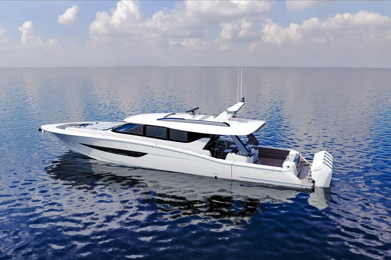 Slide: The Image of 2025 Scout 670 LXS luxury yacht on calm ocean waters under a partly cloudy sky. - 1