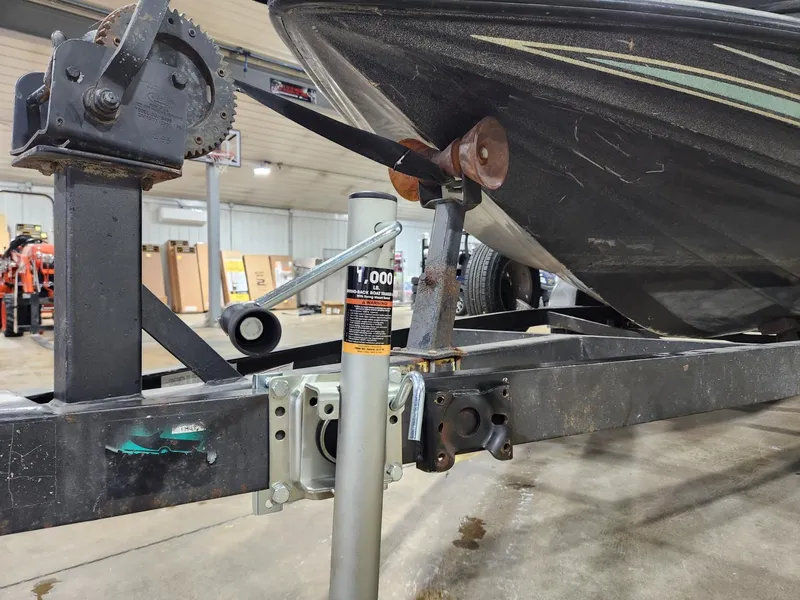 Slide: The Image of 1996 Cajun Master boat on trailer in garage, featuring winch and support jack. - 15