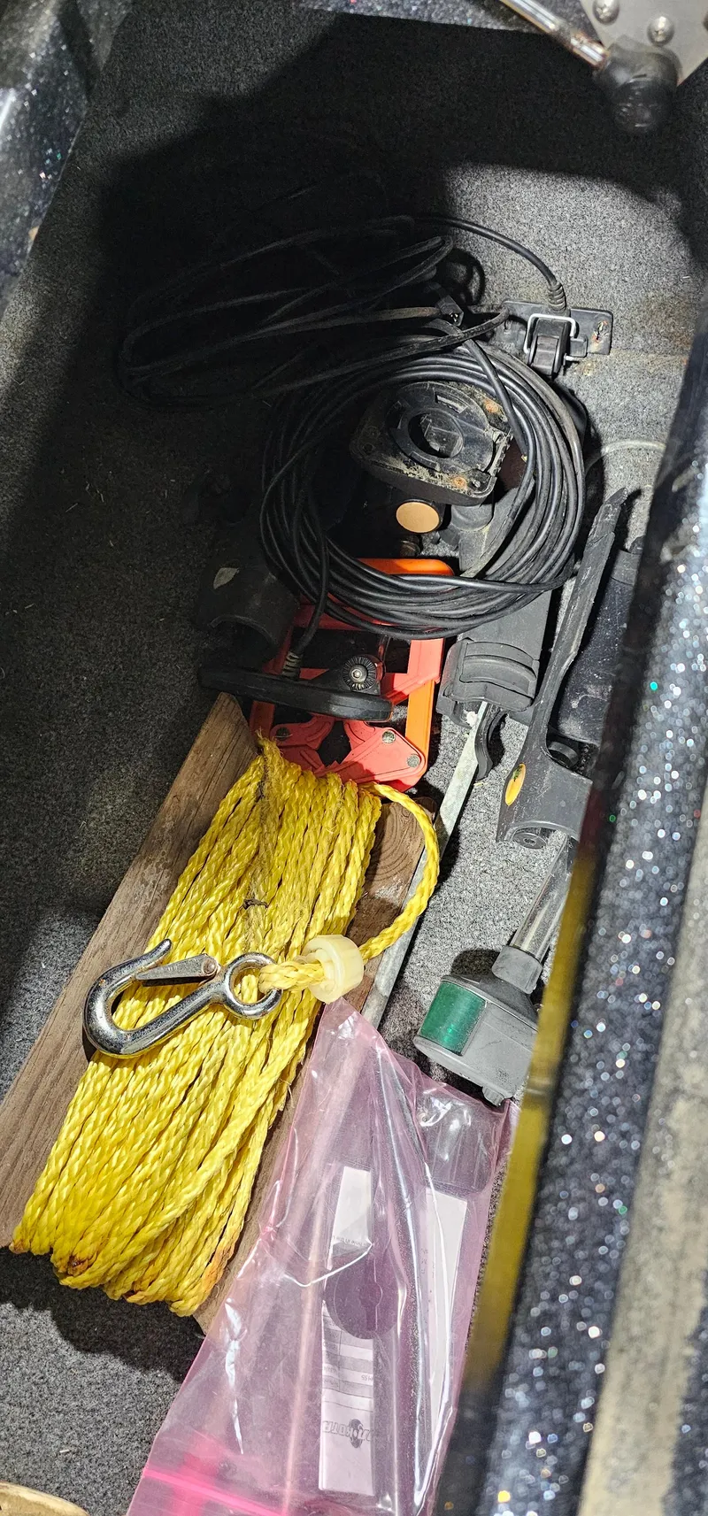 Slide: The Image of Storage compartment with tools and rope in a 1996 Cajun Master boat. - 20