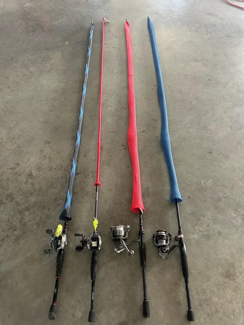 Slide: The Image of Four fishing rods with colorful sleeves on a concrete floor, Cajun Master 1996 model. - 30