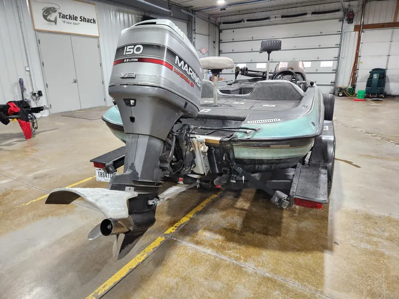 Slide: The Image of 1996 Cajun Master boat with 150 HP Mariner engine in indoor storage. - 4