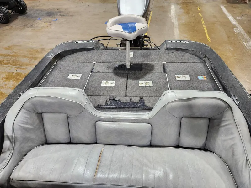 Slide: The Image of 1996 Cajun Master boat interior with gray seating and storage compartments. - 9