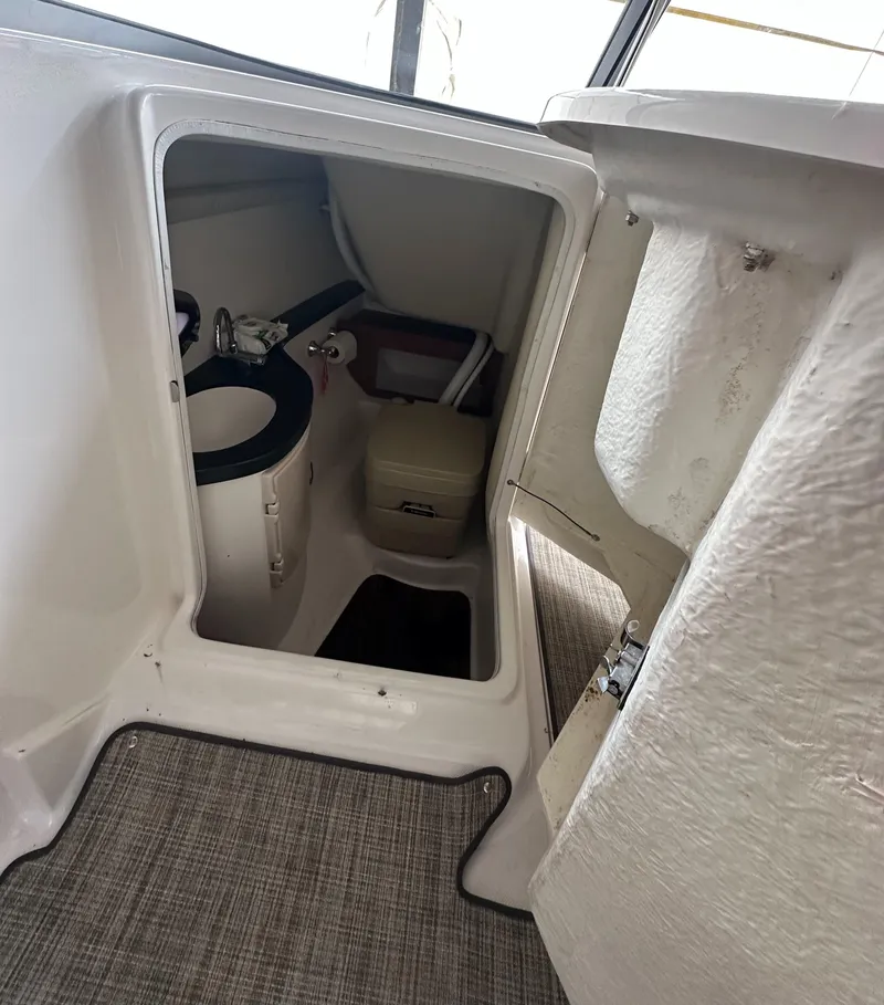 Slide: The Image of 2012 Regal 2700 Bowrider interior cabin with compact sink and seating. - 13