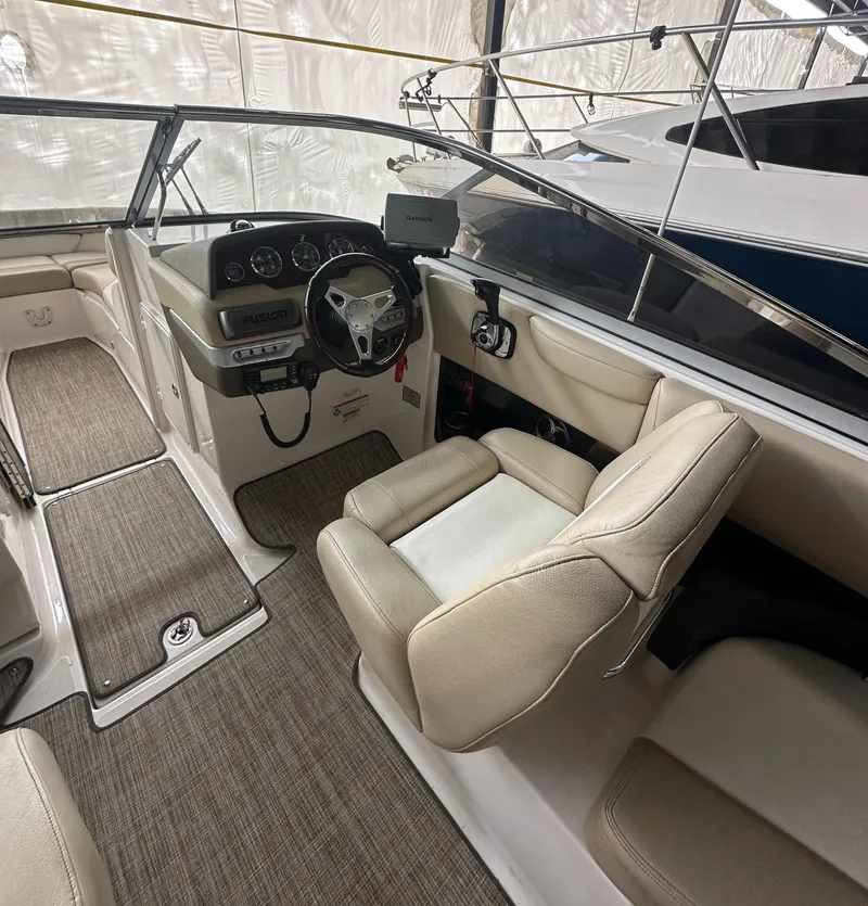 Slide: The Image of 2012 Regal 2700 Bowrider interior with beige seating and modern dashboard. - 14