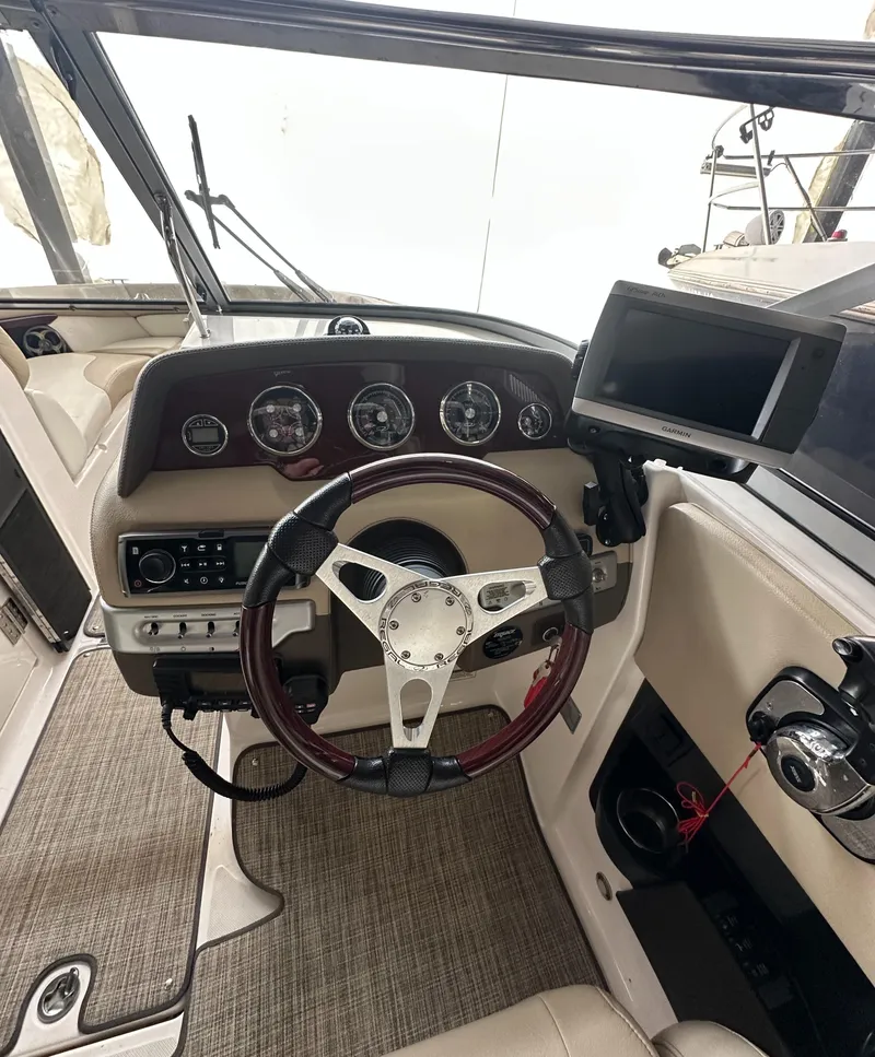 Slide: The Image of 2012 Regal 2700 Bowrider cockpit with steering wheel and dashboard controls. - 15