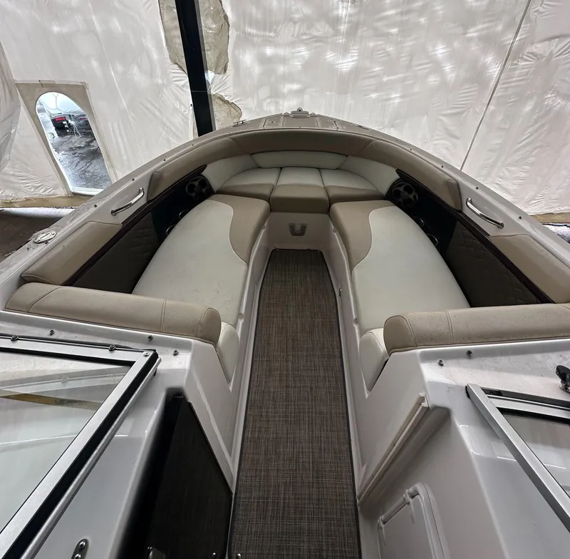 Slide: The Image of 2012 Regal 2700 Bowrider interior with beige seating and carpeted floor. - 18