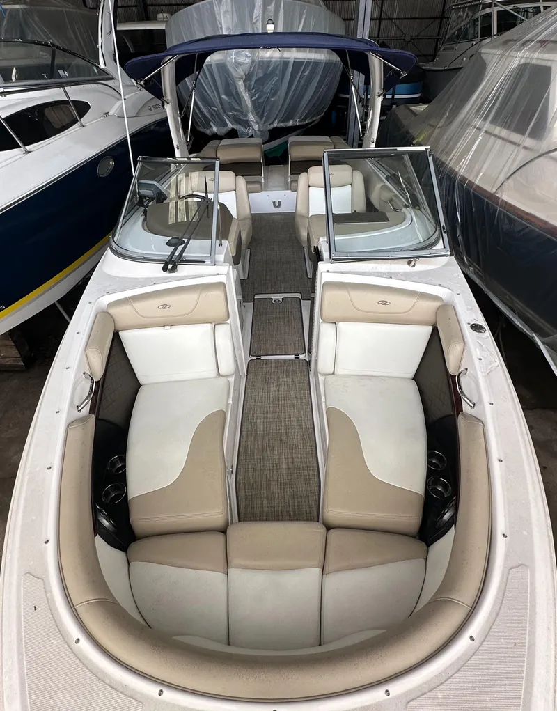 Slide: The Image of 2012 Regal 2700 Bowrider boat with spacious seating and sleek design in a marina. - 21