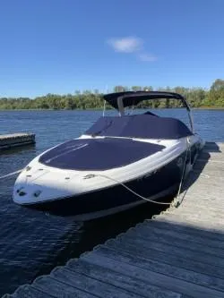 Slide: The Image of 2012 Regal 2700 Bowrider boat docked on a sunny day by a lake. - 4