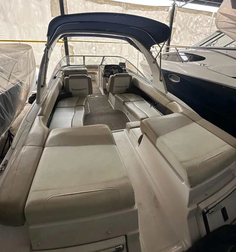 Slide: The Image of 2012 Regal 2700 Bowrider boat interior with spacious seating and canopy. - 5