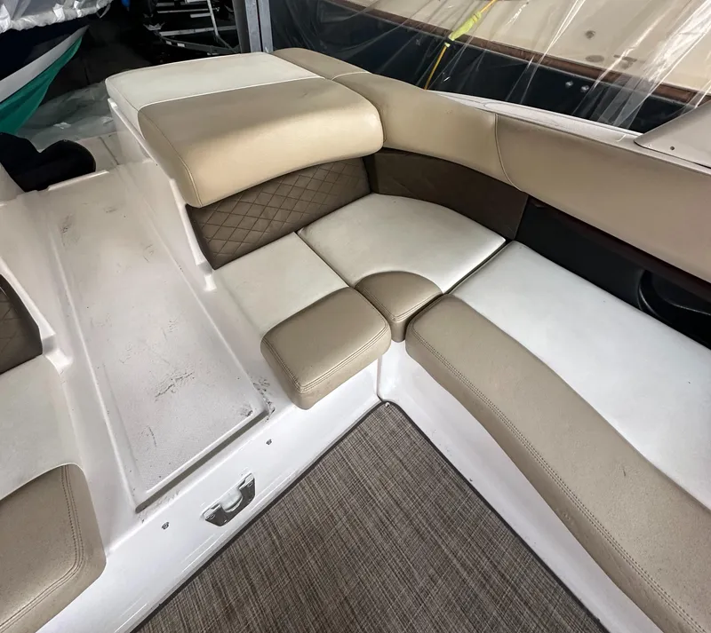 Slide: The Image of 2012 Regal 2700 Bowrider interior seating with beige and brown upholstery. - 8