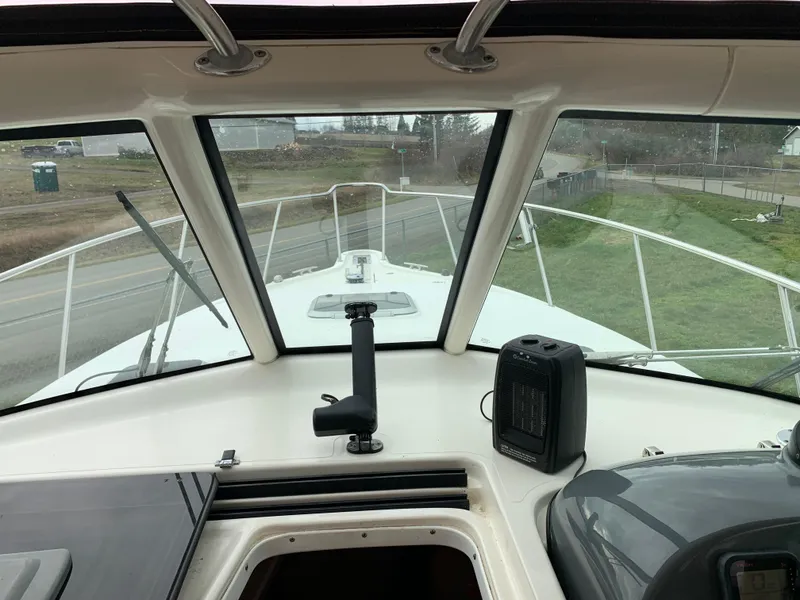 Slide: The Image of 2007 Pursuit OS 335 boat interior view with windshield and controls. - 10