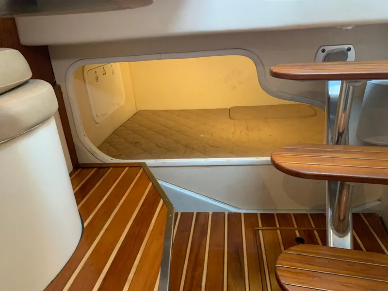 Slide: The Image of 2007 Pursuit OS 335 cabin interior with wooden steps and cozy sleeping area. - 15