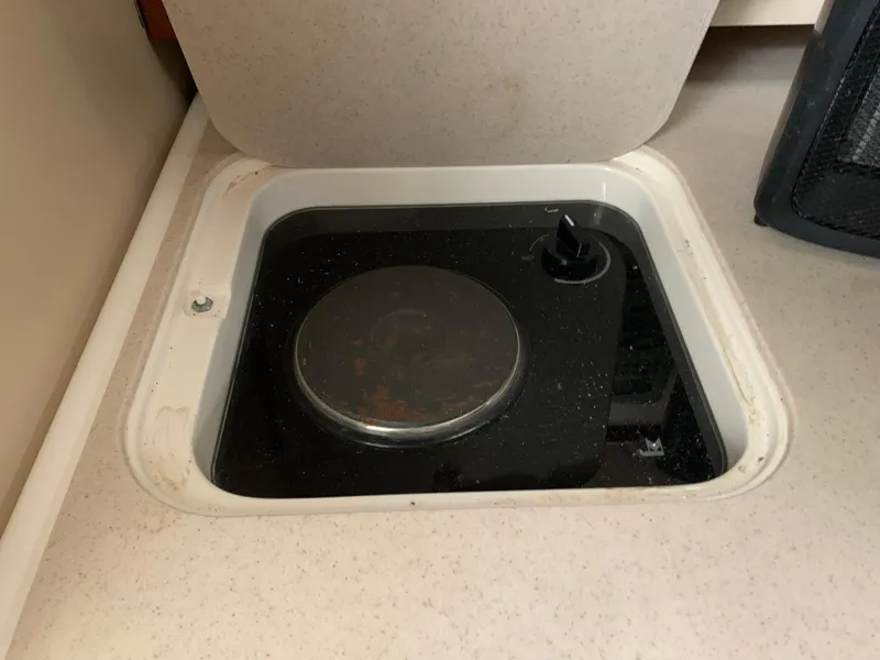 Slide: The Image of 2007 Pursuit OS 335 boat stove with a single burner and control knob. - 18