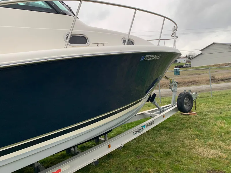 Slide: The Image of 2007 Pursuit OS 335 boat on trailer, parked on grass. - 2