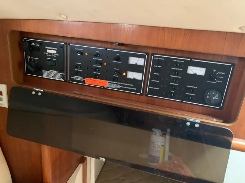 Slide: The Image of Control panel inside a 2007 Pursuit OS 335 boat, featuring various switches and gauges. - 21