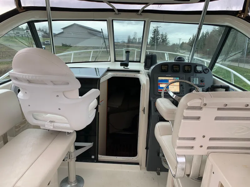 Slide: The Image of 2007 Pursuit OS 335 boat interior with helm, seating, and navigation equipment. - 6