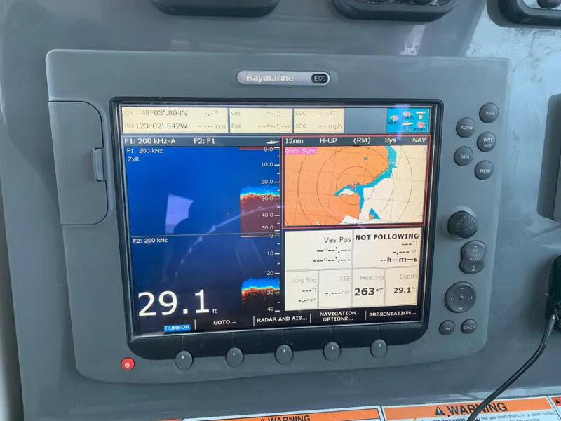 Slide: The Image of Close-up of a 2007 Pursuit OS 335 boat navigation system displaying sonar and map data. - 8