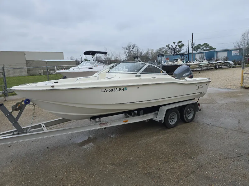 Slide: The Image of 2003 Scout 202 Dorado boat on trailer in a parking lot. - 7