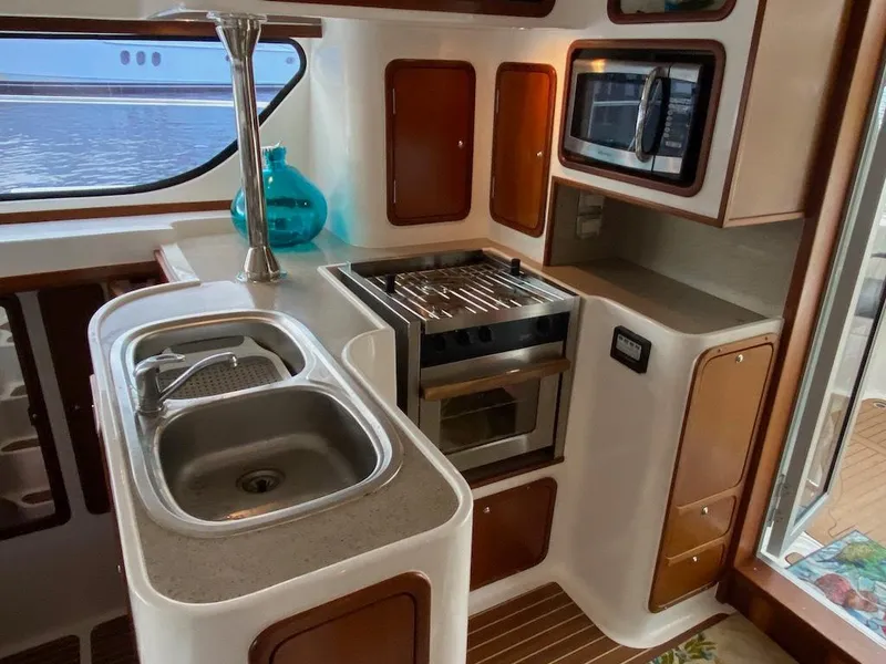 Slide: The Image of Compact kitchen in 2013 Africat Marine AfriCat PowerCat Sportfisher with sink, stove, and microwave. - 13