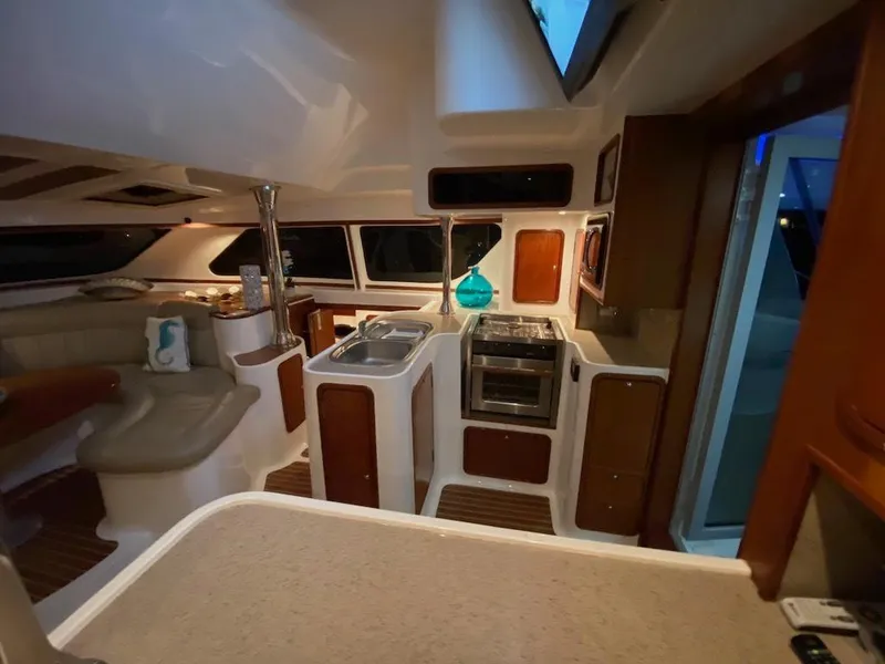 Slide: The Image of Interior of 2013 Africat Marine AfriCat PowerCat Sportfisher, featuring modern kitchen and seating area. - 19