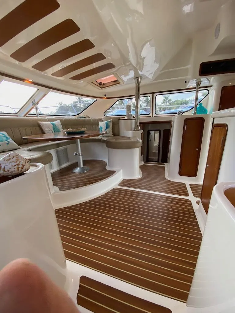 Slide: The Image of 2013 Africat Marine AfriCat PowerCat Sportfisher interior with wood flooring and seating area. - 27