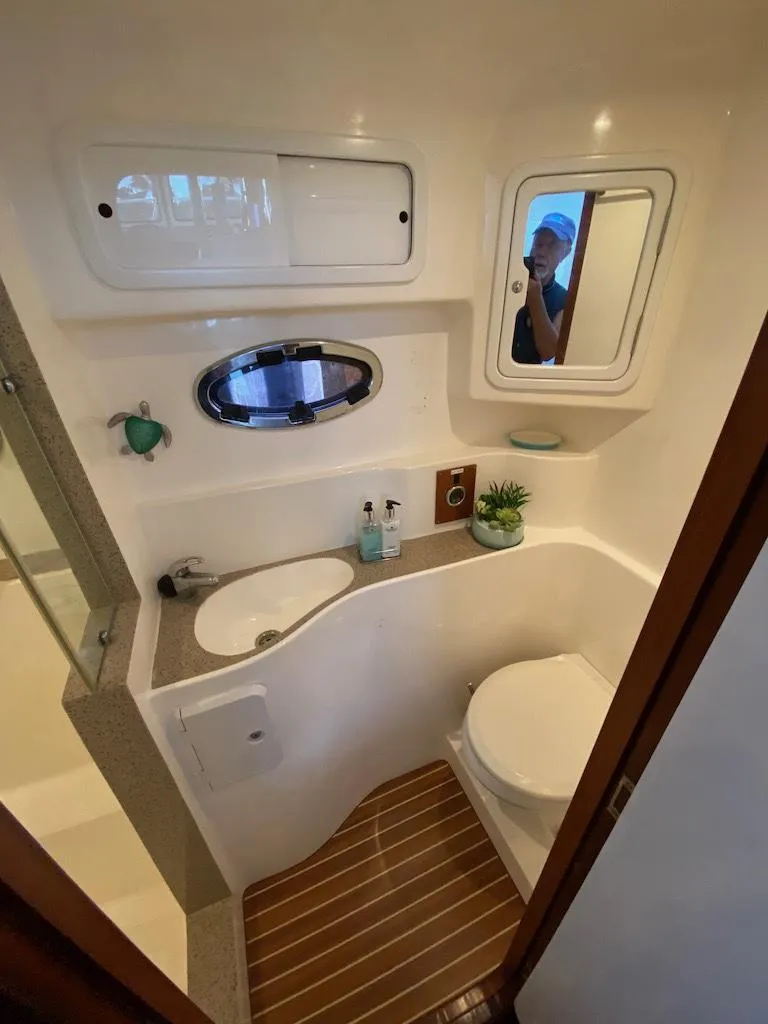 Slide: The Image of 2013 Africat PowerCat Sportfisher bathroom with modern fixtures and wooden flooring. - 30
