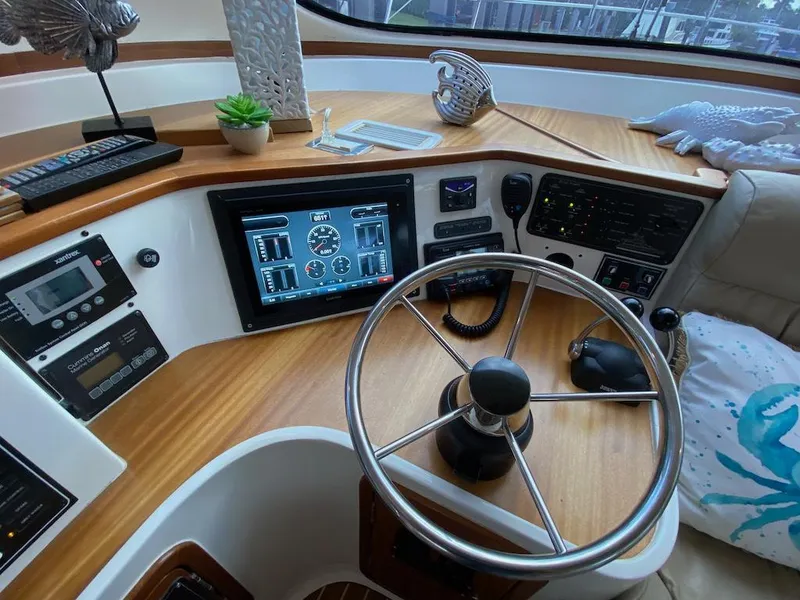 Slide: The Image of Helm of 2013 Africat Marine AfriCat PowerCat Sportfisher with modern controls and wooden accents. - 34