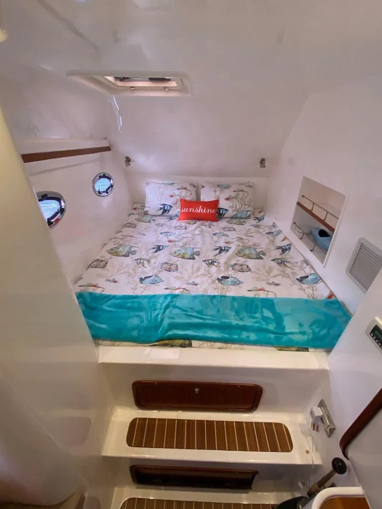 Slide: The Image of 2013 Africat Marine AfriCat PowerCat Sportfisher cabin with bed, portholes, and nautical decor. - 35