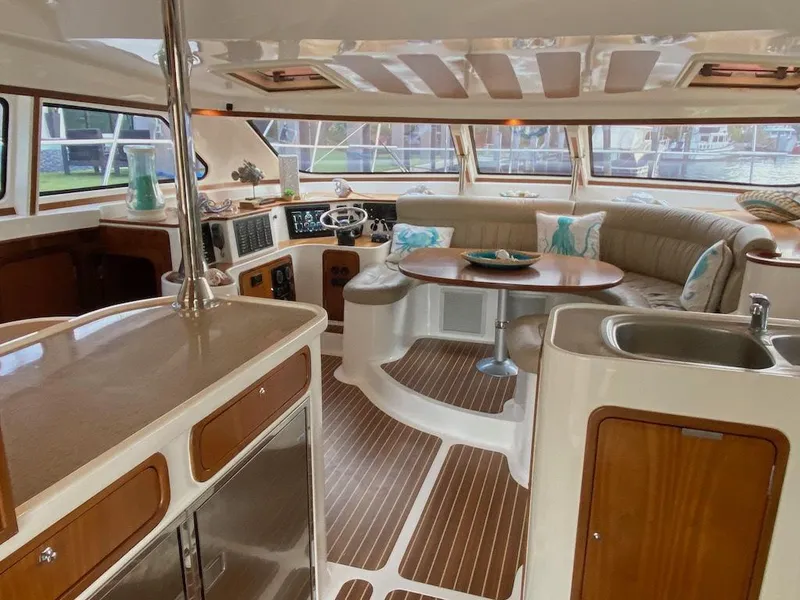 Slide: The Image of 2013 Africat Marine PowerCat Sportfisher interior with modern kitchen and seating area. - 4