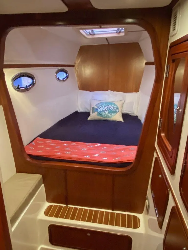 Slide: The Image of 2013 Africat Marine AfriCat PowerCat Sportfisher cabin with cozy bed and wooden interior. - 40