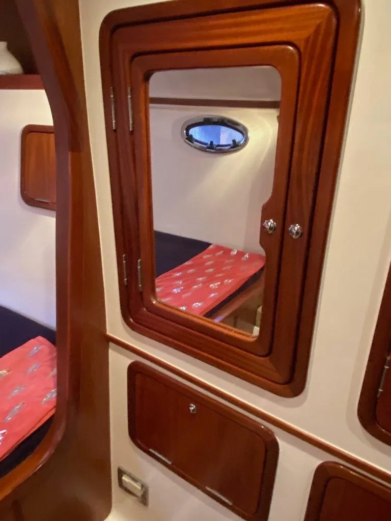 Slide: The Image of 2013 Africat PowerCat Sportfisher cabin interior with wooden finishes and porthole window. - 42