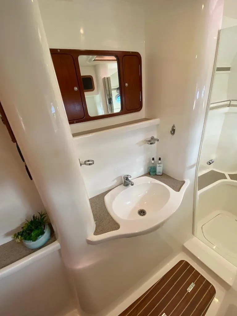 Slide: The Image of 2013 Africat PowerCat Sportfisher bathroom with sink, mirror, and wooden floor accents. - 46