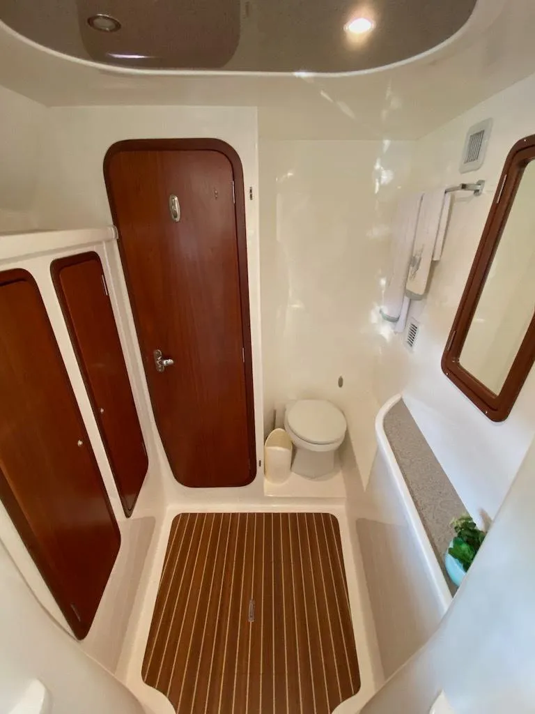Slide: The Image of 2013 Africat PowerCat Sportfisher bathroom with wood accents and modern fixtures. - 48